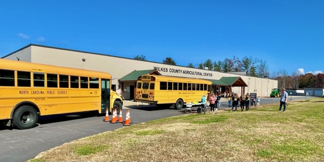 School buses in front of the Wilkes County Agricultural Center.