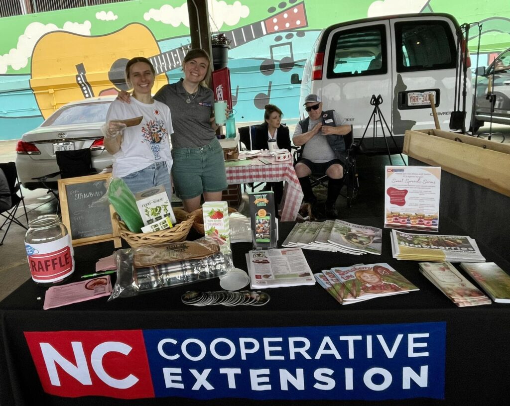 N.C. Cooperative extension table at a farmers market.